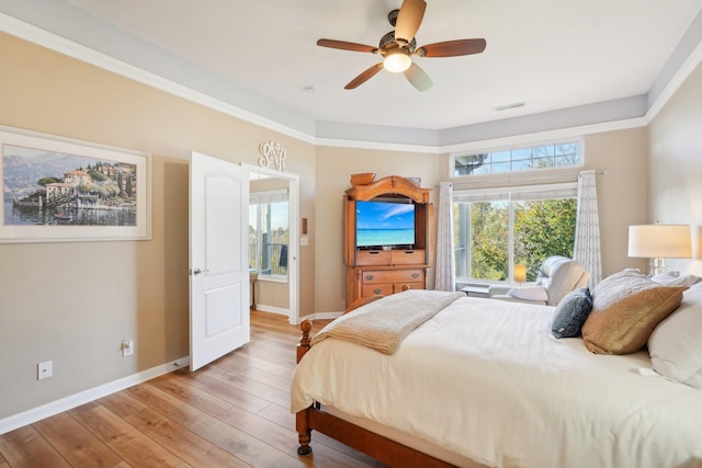 bedroom featuring baseboards, multiple windows, visible vents, and light wood-style floors