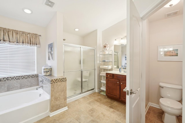 bathroom featuring toilet, a stall shower, vanity, and visible vents