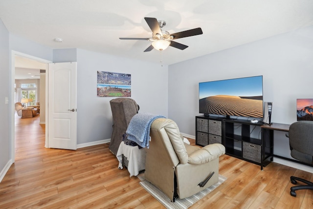 office featuring baseboards, ceiling fan, and light wood finished floors