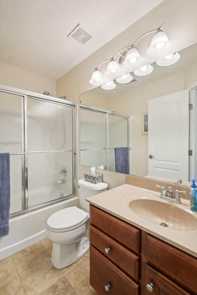 full bath featuring bath / shower combo with glass door, visible vents, toilet, vanity, and tile patterned flooring