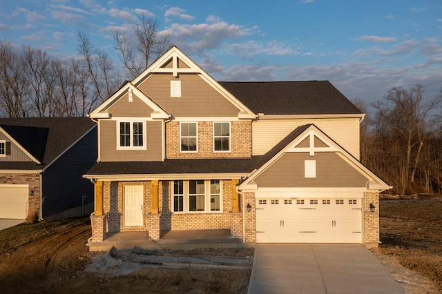 craftsman-style house featuring concrete driveway and brick siding