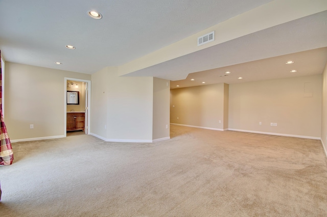 empty room with recessed lighting, visible vents, baseboards, and light colored carpet