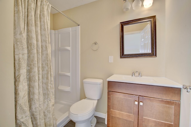 bathroom with toilet, vanity, and a shower with shower curtain