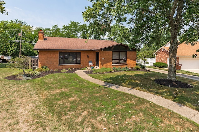 ranch-style home with a front lawn