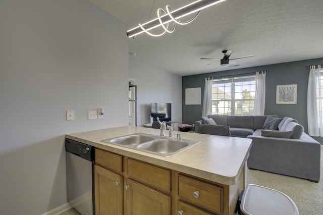 kitchen with dishwasher, open floor plan, a peninsula, light countertops, and a sink