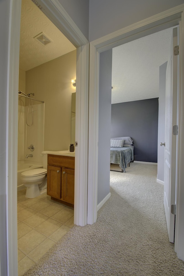 bathroom with shower / bath combination, visible vents, vanity, a textured ceiling, and tile patterned flooring