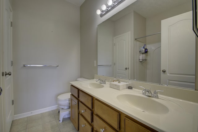 full bath with double vanity, baseboards, toilet, tile patterned floors, and a sink