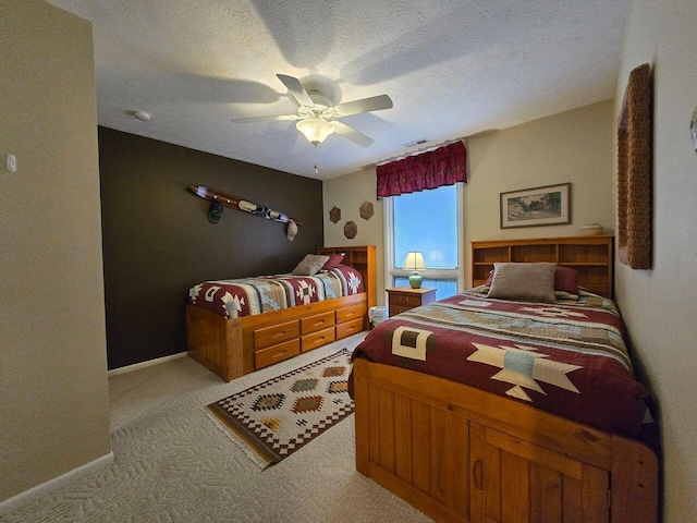 bedroom with light colored carpet, visible vents, a ceiling fan, a textured ceiling, and baseboards