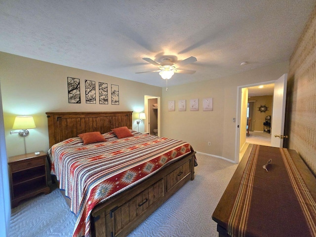 carpeted bedroom with a textured ceiling, a ceiling fan, and baseboards