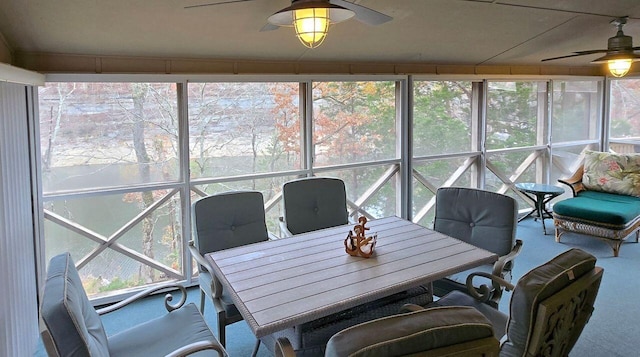 sunroom / solarium featuring a ceiling fan