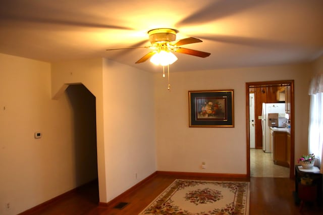 empty room with hardwood / wood-style flooring and ceiling fan