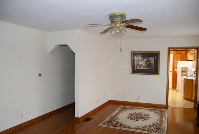 spare room with ceiling fan and dark hardwood / wood-style floors