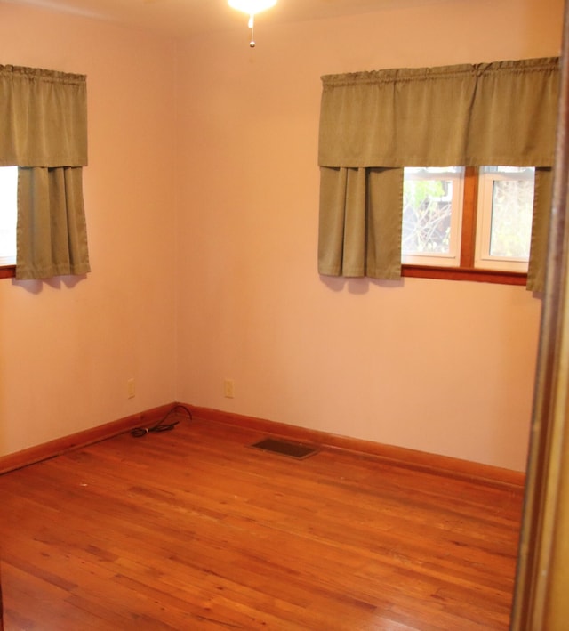 unfurnished room featuring hardwood / wood-style floors