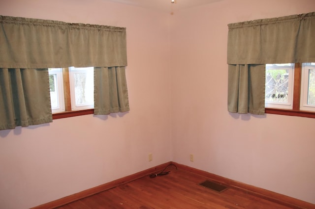 unfurnished room featuring hardwood / wood-style floors