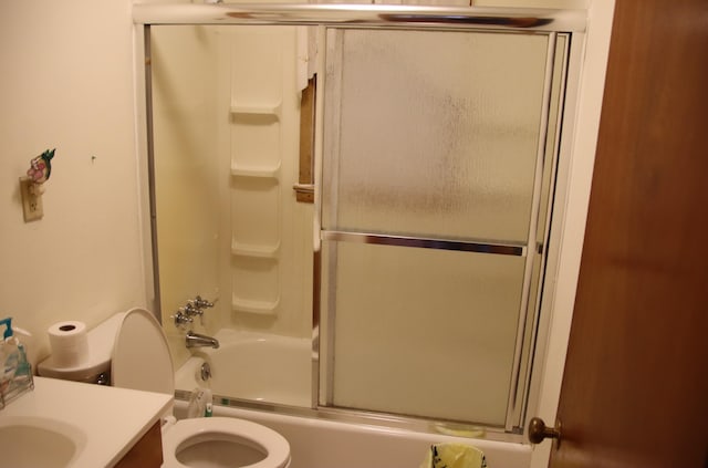 full bathroom featuring vanity, enclosed tub / shower combo, and toilet