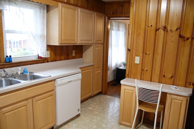 kitchen with sink, white dishwasher, and light brown cabinets