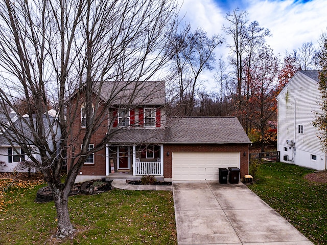 colonial inspired home featuring a front lawn, covered porch, and a garage