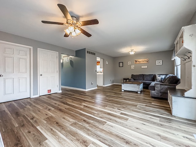 living room with wood-type flooring and ceiling fan