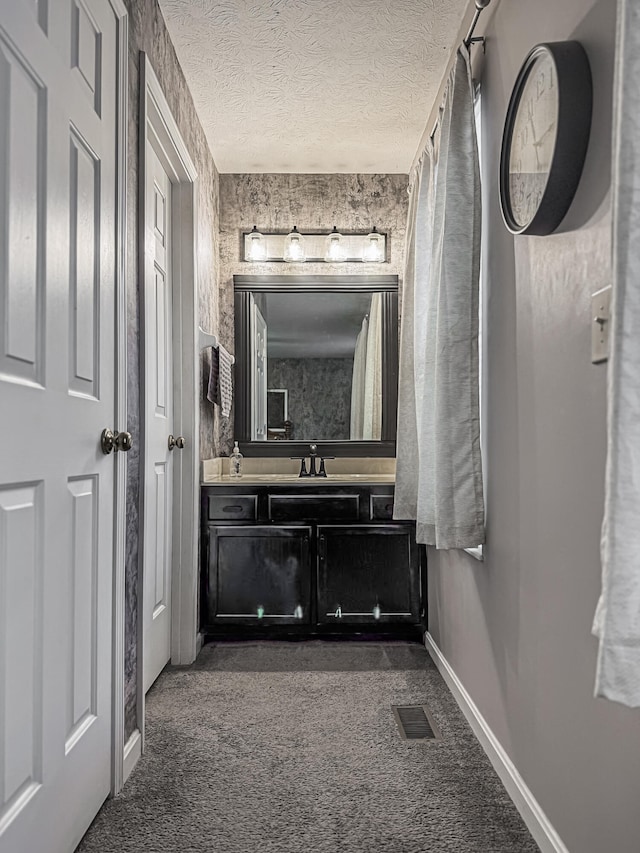 bathroom with vanity and a textured ceiling