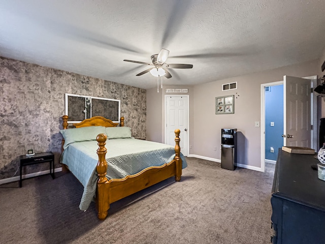 carpeted bedroom with ceiling fan and a textured ceiling