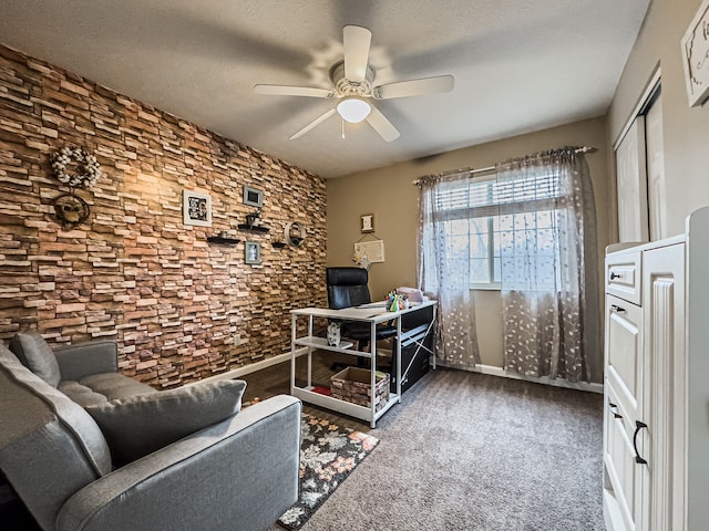 carpeted home office with ceiling fan and a textured ceiling