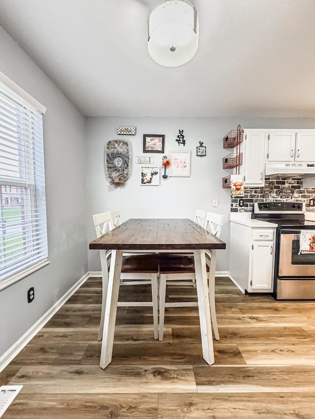 unfurnished dining area featuring hardwood / wood-style floors and a healthy amount of sunlight