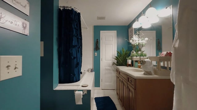 bathroom featuring tile patterned floors, a notable chandelier, and vanity