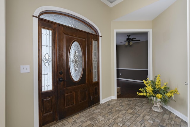 foyer entrance featuring brick floor and baseboards