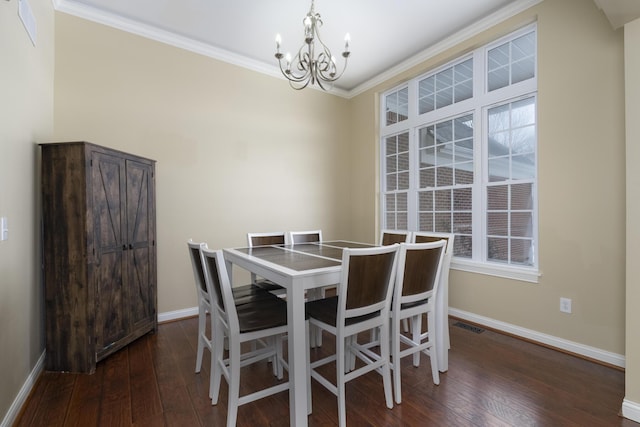 dining space featuring an inviting chandelier, hardwood / wood-style flooring, baseboards, and ornamental molding