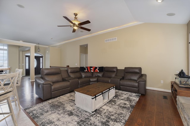 living room with crown molding, ceiling fan, dark hardwood / wood-style flooring, and vaulted ceiling