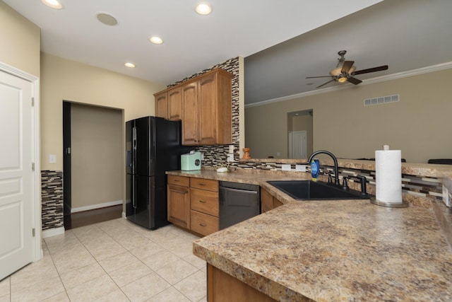 kitchen featuring tasteful backsplash, visible vents, dishwashing machine, black fridge with ice dispenser, and a sink