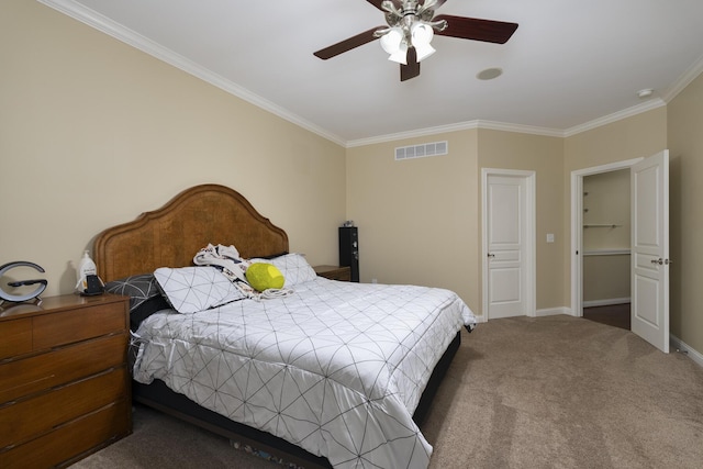 carpeted bedroom with crown molding and ceiling fan