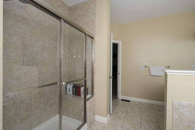 full bathroom with tile patterned floors, baseboards, a stall shower, and visible vents