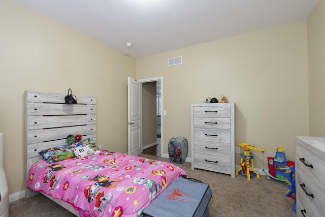 carpeted bedroom featuring visible vents and baseboards