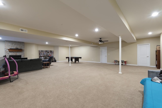 interior space featuring light carpet, pool table, and a fireplace