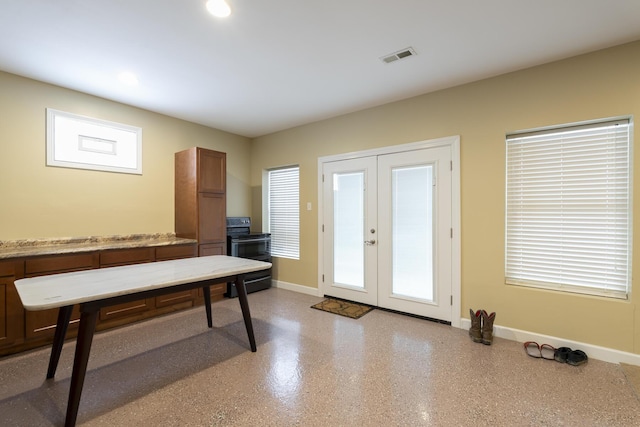 interior space with french doors, visible vents, and baseboards