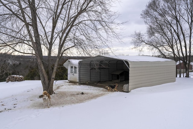 snow covered structure featuring a carport