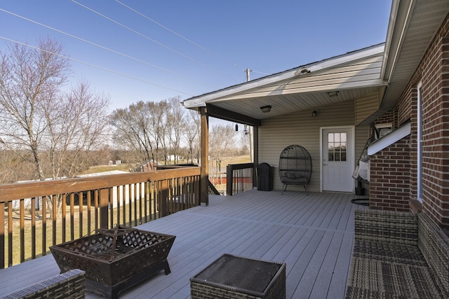 wooden deck with a fire pit