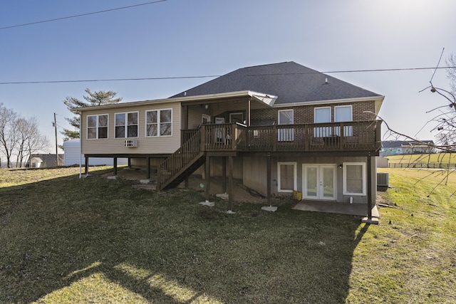 rear view of house featuring french doors, a yard, a wooden deck, and stairway