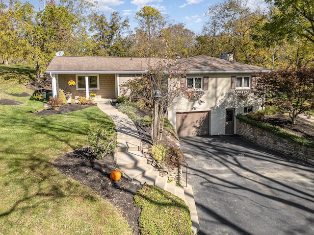 ranch-style house with a garage and a front yard