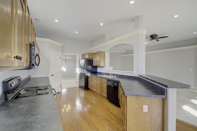 kitchen with kitchen peninsula, ceiling fan with notable chandelier, sink, black appliances, and light hardwood / wood-style floors