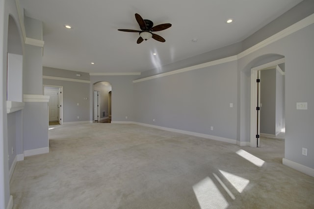 unfurnished living room featuring ceiling fan, ornamental molding, and light carpet