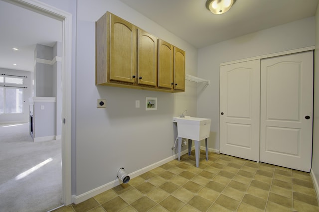 washroom featuring washer hookup, light carpet, cabinets, and hookup for an electric dryer