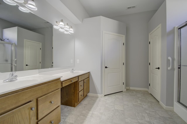 bathroom featuring vanity and an enclosed shower