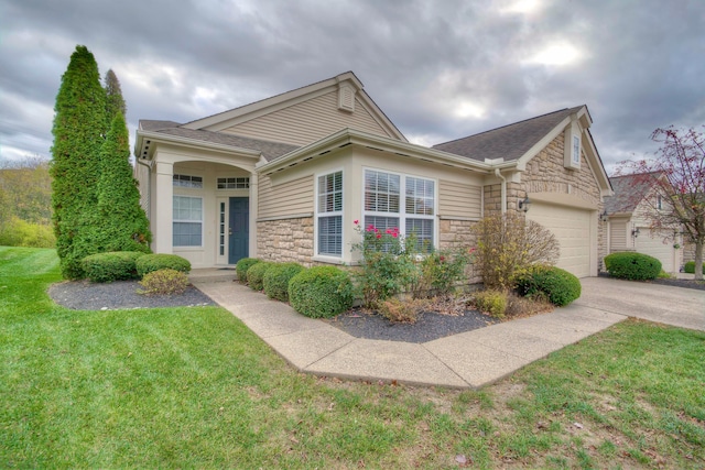 view of front of house with a front yard and a garage