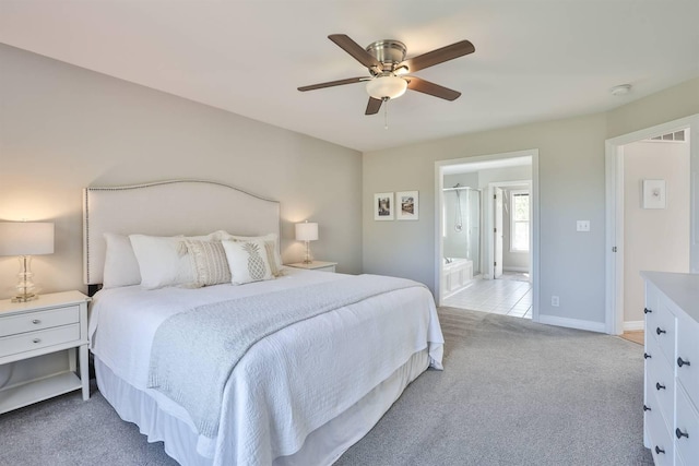 carpeted bedroom with ceiling fan and ensuite bathroom