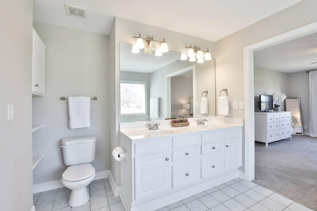 bathroom with toilet, vanity, tile patterned floors, and ceiling fan