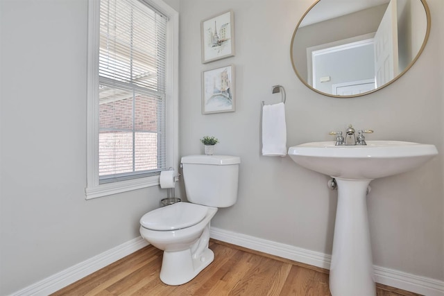 bathroom with hardwood / wood-style floors, toilet, and sink