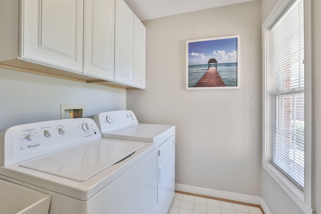 washroom with cabinets and washer and clothes dryer