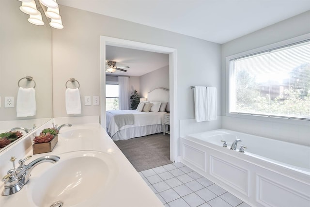 bathroom with tile patterned floors, a washtub, ceiling fan, and vanity